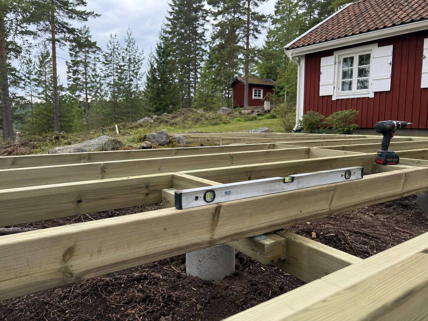 Joists on concrete footings for a new deck, spirit level on the joist